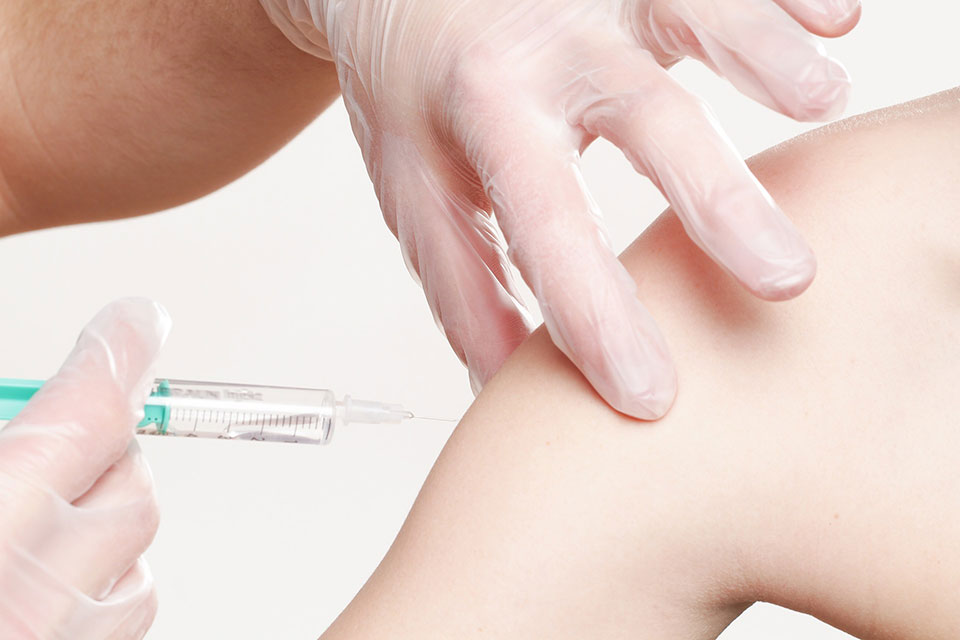 Medical Professional Prepares to Give Patient Vaccination