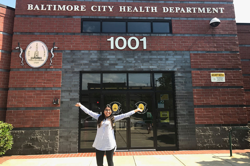Student Pharmacist Iqra Khaleel Poses in Front of the Baltimore City Health Department.