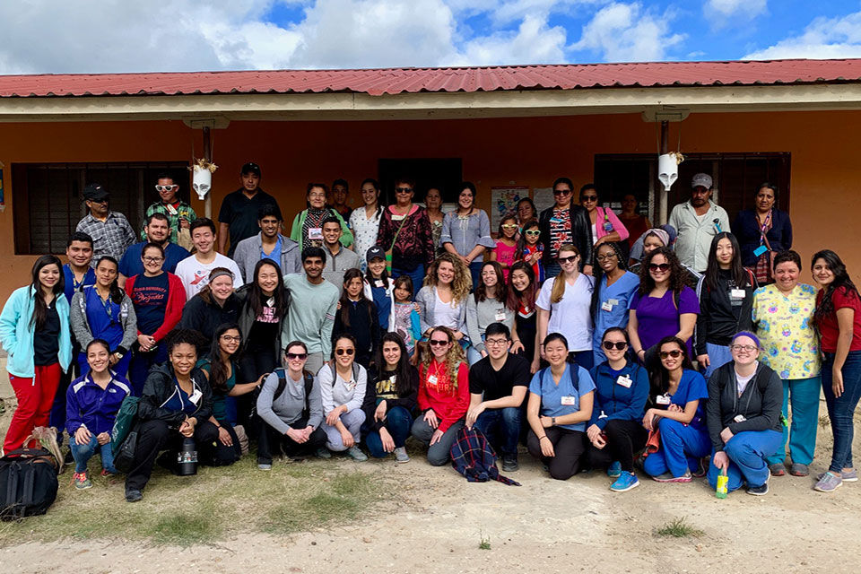 Global Medical Brigades students pose for photo with health care providers in Honduras.