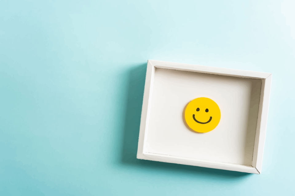 smiley face in a picture frame with light blue background