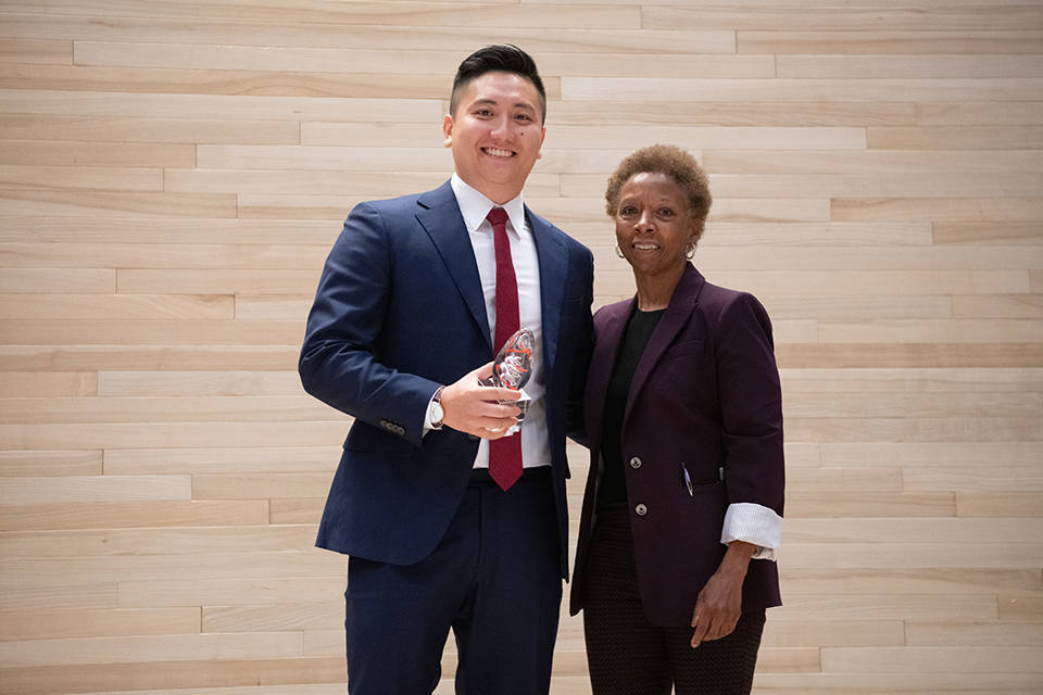 Kun Yang stands with Dean Natalie Eddington after he gave the keynote address at the 2022 white coat ceremony.