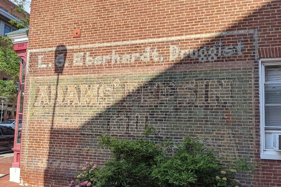 Faded sign on brick wall of the LG Eberhardt, Druggist store.