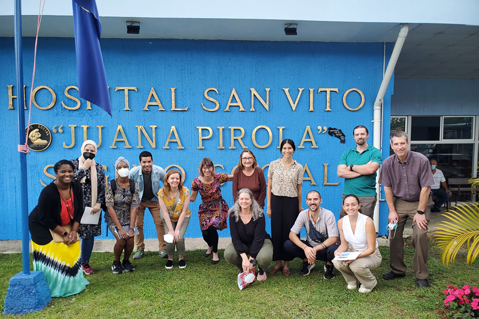 Group shot in front of a hospital sign in Costa Rica